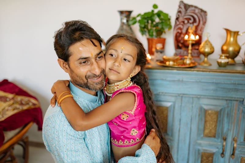 A father hugging his daughter at home