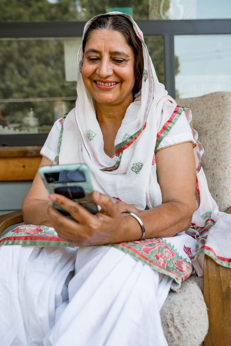 A woman smiling at her phone